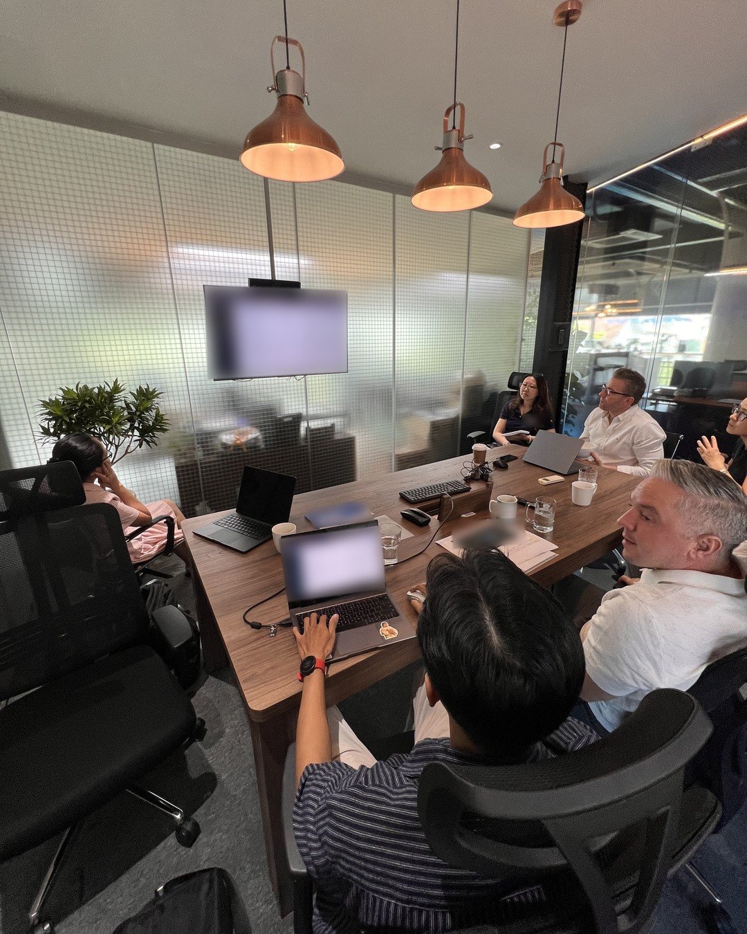 The Saigon Digital team demoing an AI implementation to a client's operations team, with screens blurred